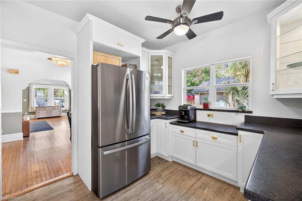 2149 Stella Street Fort Myers, FL 33901 - Photo 11 of 43 a kitchen with granite countertop a refrigerator a sink and white cabinets