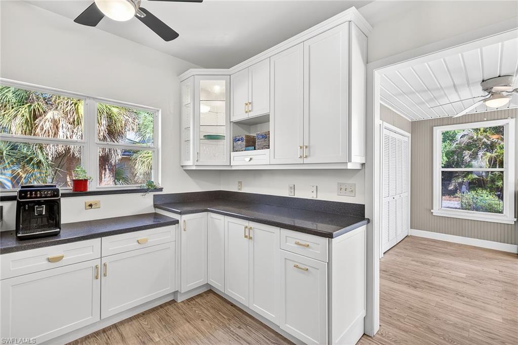 2149 Stella Street Fort Myers, FL 33901 - Photo 12 of 43 a kitchen with stainless steel appliances granite countertop white cabinets and window
