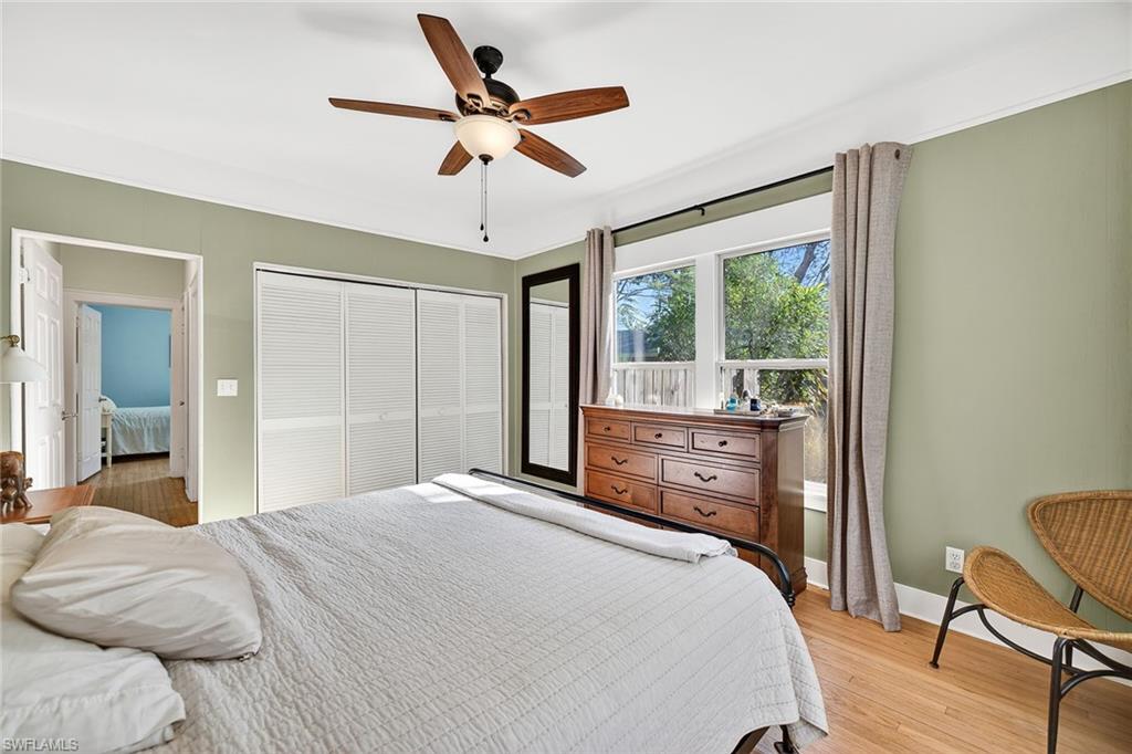 2149 Stella Street Fort Myers, FL 33901 - Photo 17 of 43 a bedroom with a bed and a chandelier