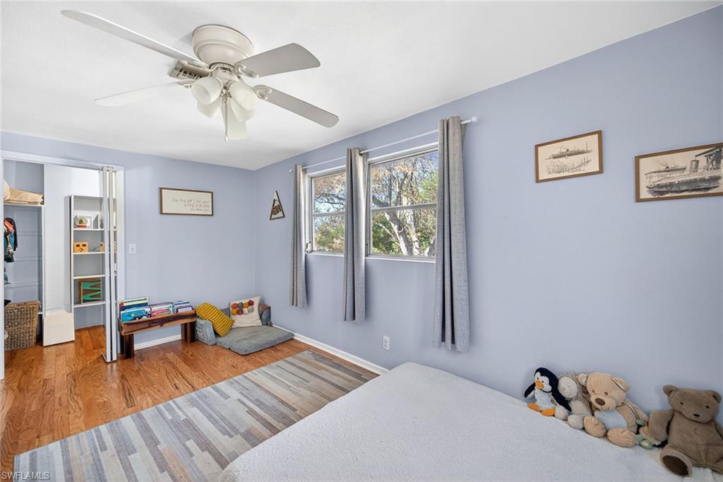 2149 Stella Street Fort Myers, FL 33901 - Photo 23 of 43 a bedroom with a bed and wooden floor