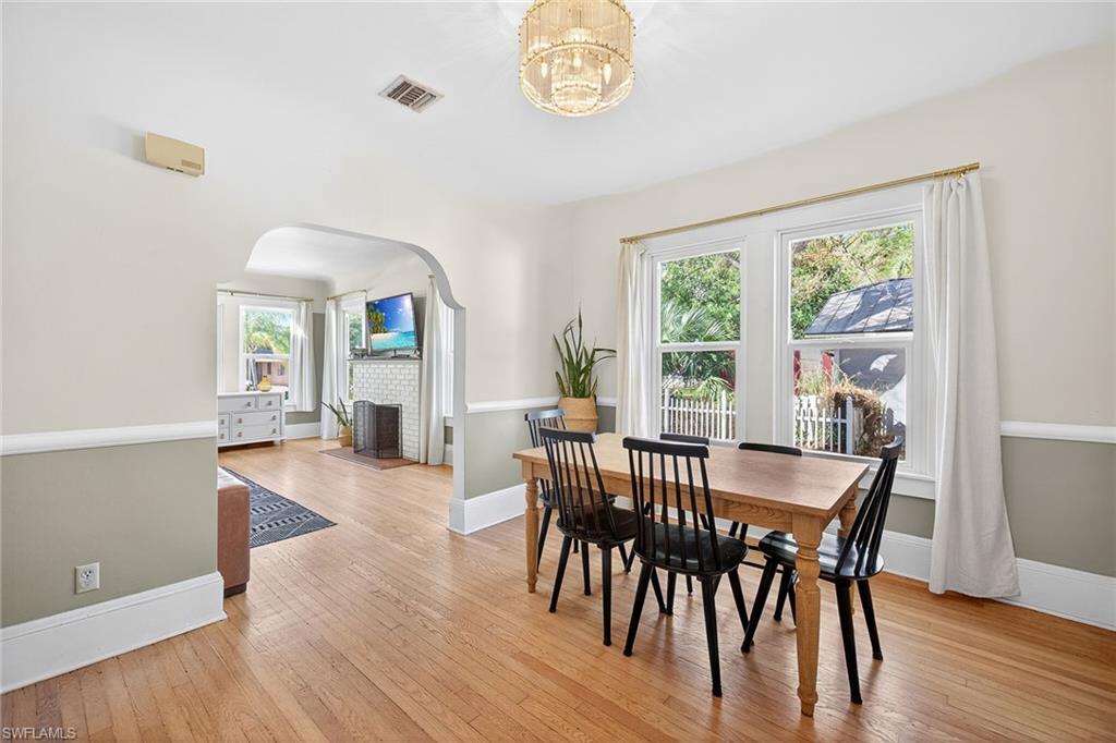 2149 Stella Street Fort Myers, FL 33901 - Photo 10 of 43 a view of a dining room with furniture a chandelier and wooden floor