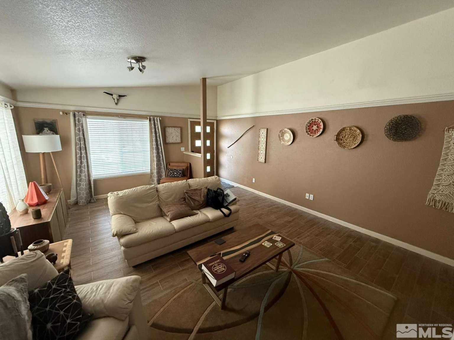 18641 Jutewood Court Reno, NV 89508 - Photo 4 of 12 a living room with furniture and a flat screen tv