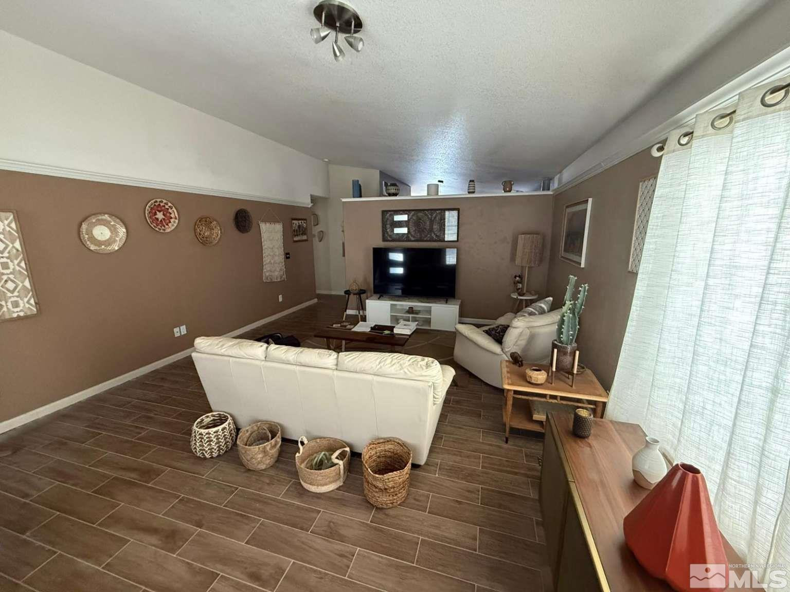 18641 Jutewood Court Reno, NV 89508 - Photo 5 of 12 a room with wooden floor and gym equipment