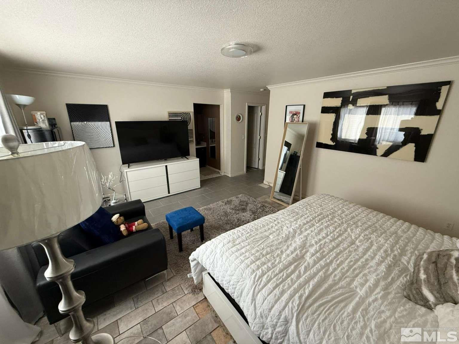 18641 Jutewood Court Reno, NV 89508 - Photo 7 of 12 a bedroom with furniture and a flat screen tv