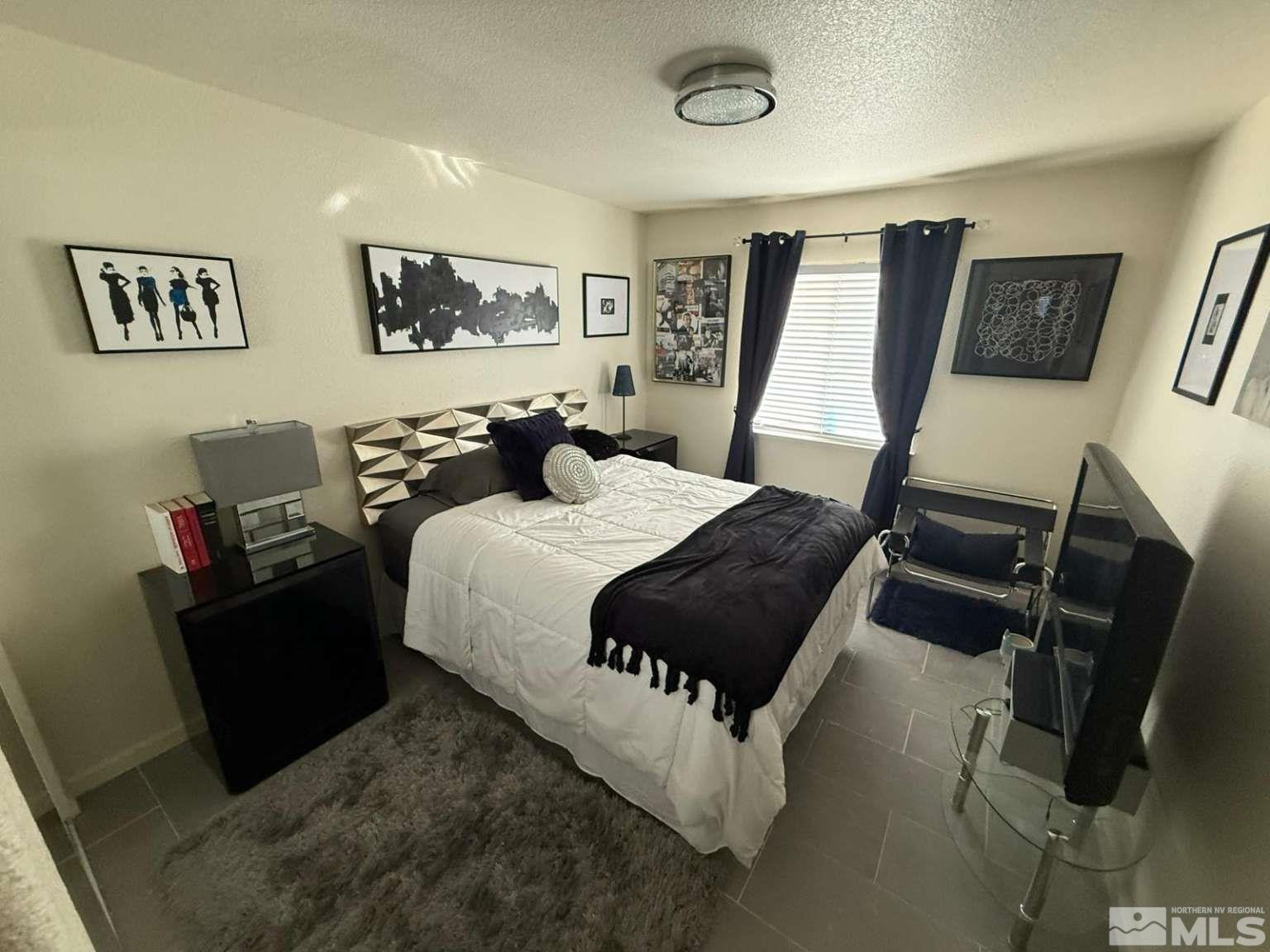 18641 Jutewood Court Reno, NV 89508 - Photo 8 of 12 a bedroom with a bed and wooden floor