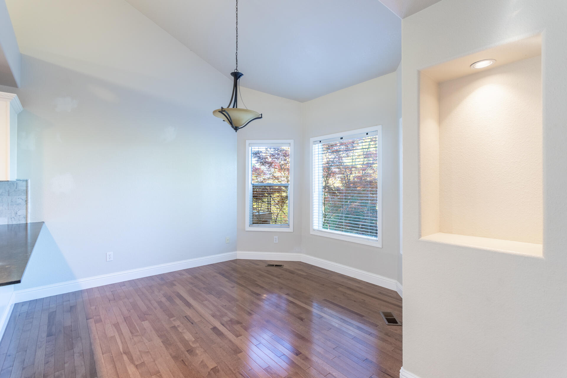 3126 Riesling Path Redding, CA 96001 - Photo 11 of 32 a view of an empty room with wooden floor and a window