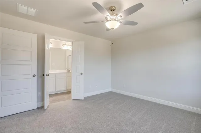 an empty room with a ceiling fan