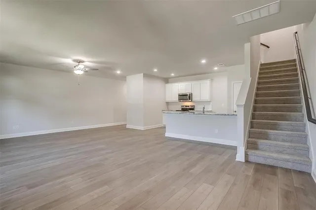 a view of kitchen and hall with wooden floor