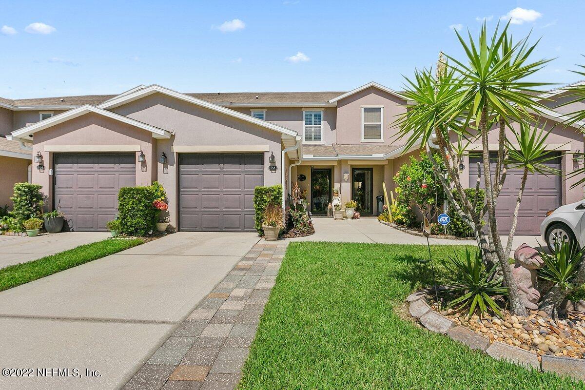 658 Cabernet Place St. Augustine, FL 32084 - Photo 1 of 11 a front view of a house with a yard and potted plants
