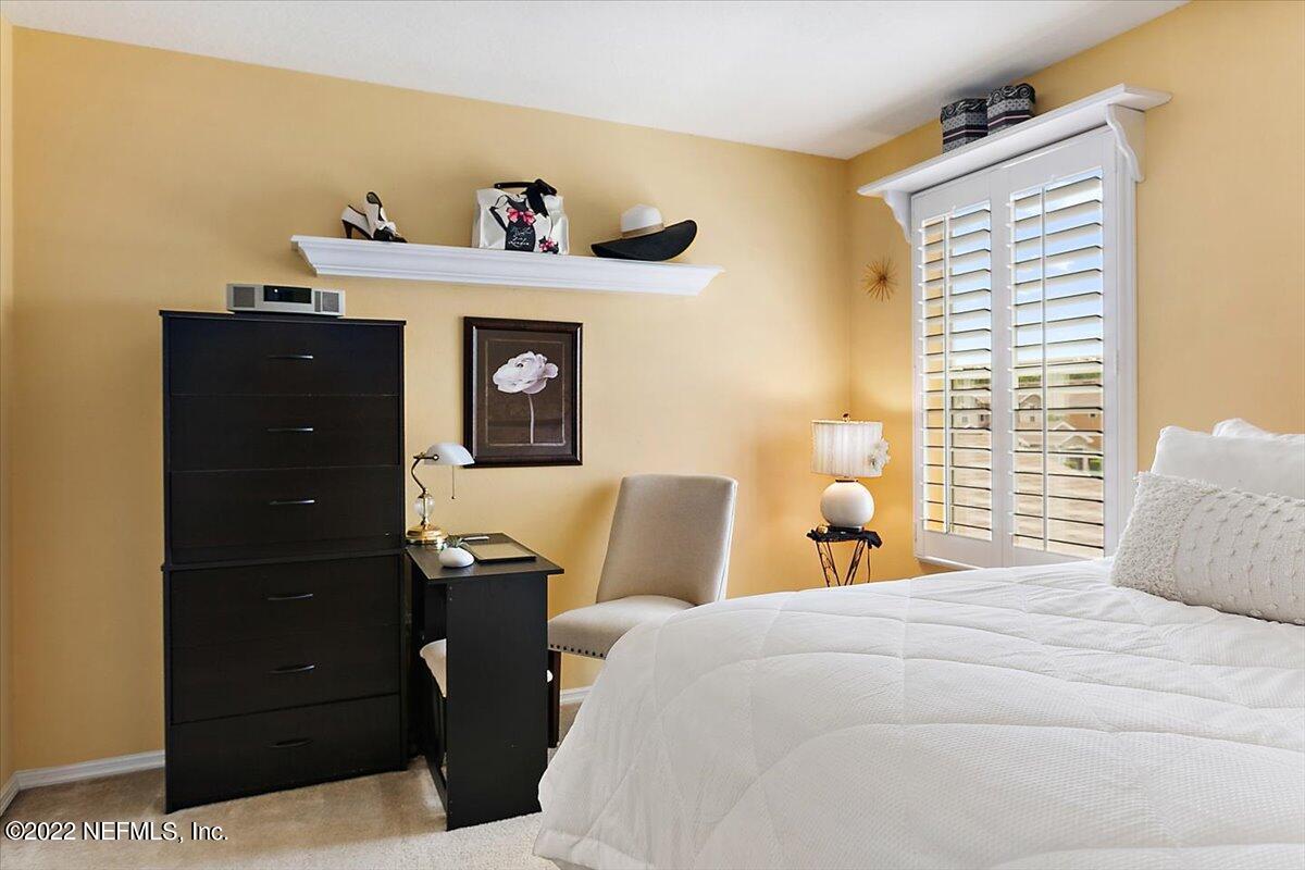 658 Cabernet Place St. Augustine, FL 32084 - Photo 8 of 11 a bedroom with a bed and a dresser