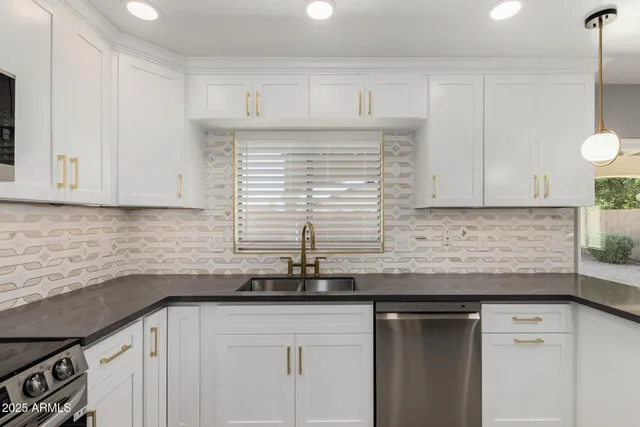 a kitchen with granite countertop cabinets sink and window