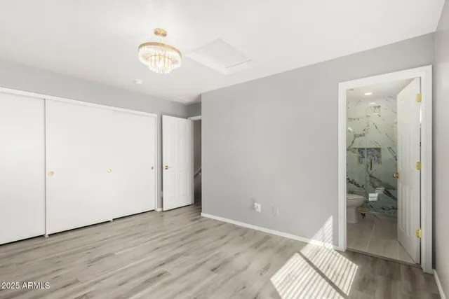 a view of a room with wooden floor and bathroom view