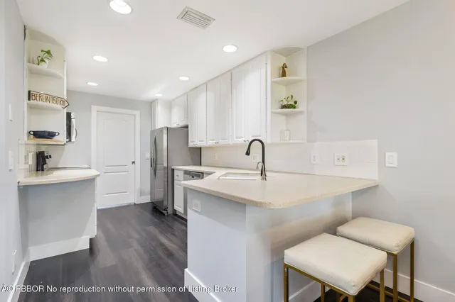 a kitchen with a sink a toilet and mirror