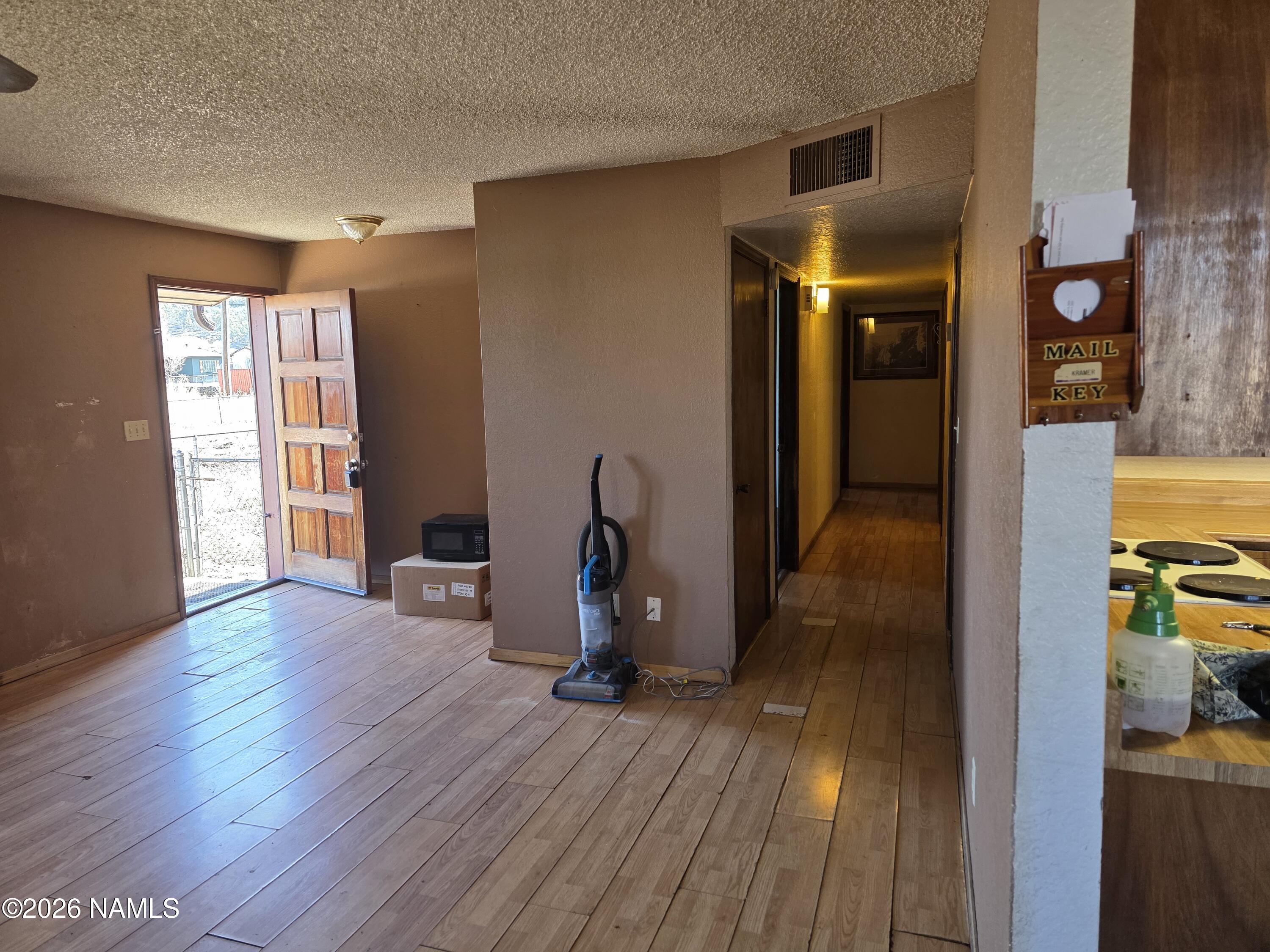 218 East Edison Avenue Williams, AZ 86046 - Photo 13 of 29 a view of empty room with wooden floor and fan