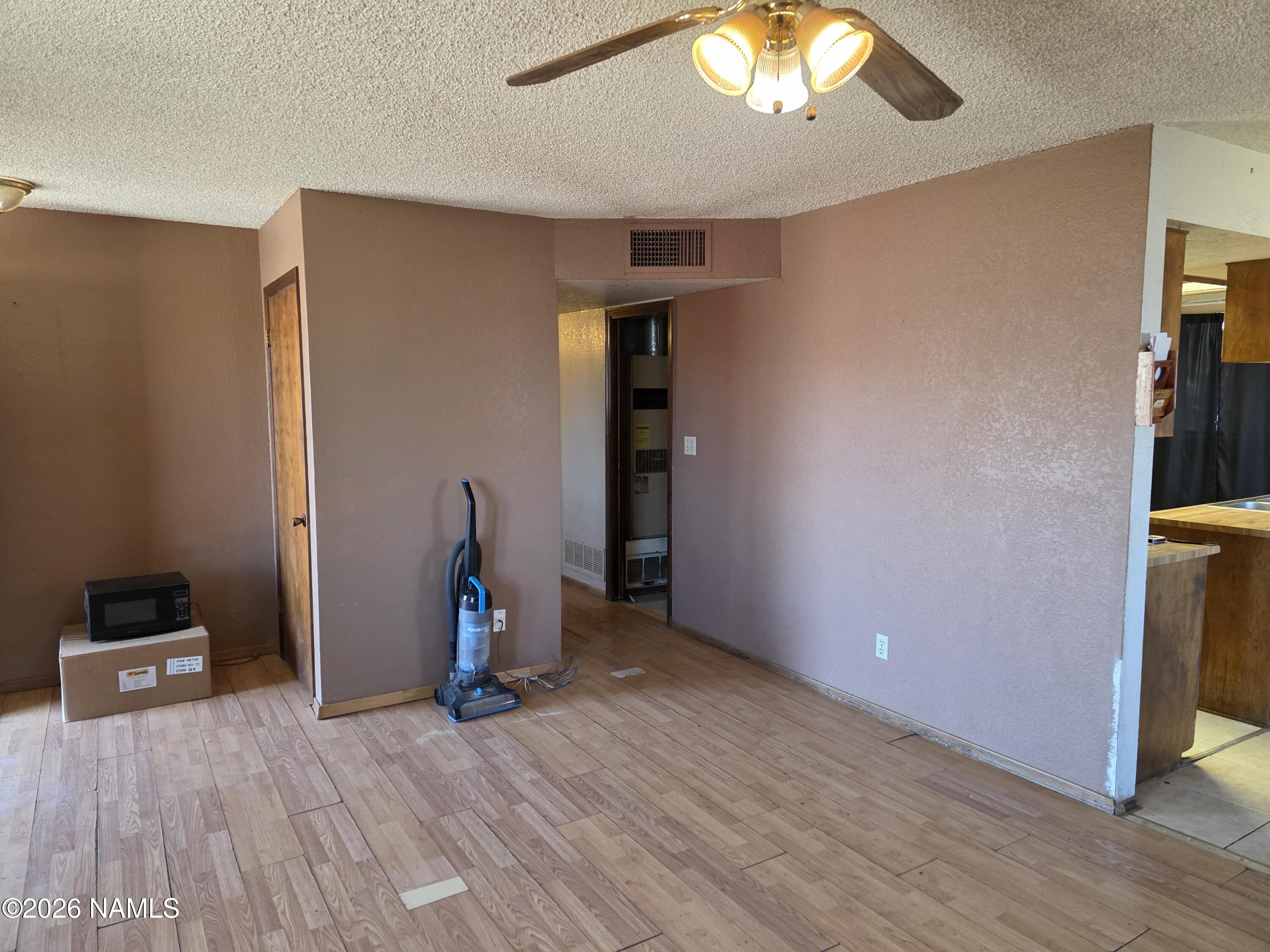 218 East Edison Avenue Williams, AZ 86046 - Photo 19 of 29 a view of empty room with wooden floor