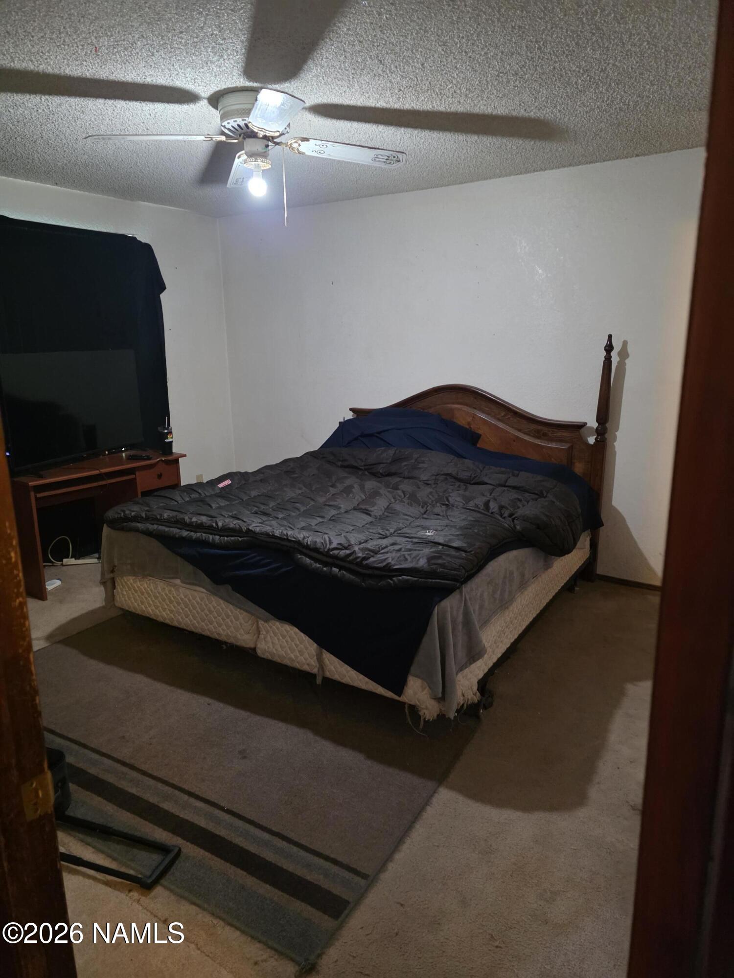 218 East Edison Avenue Williams, AZ 86046 - Photo 24 of 29 a bedroom with a bed and a chandelier