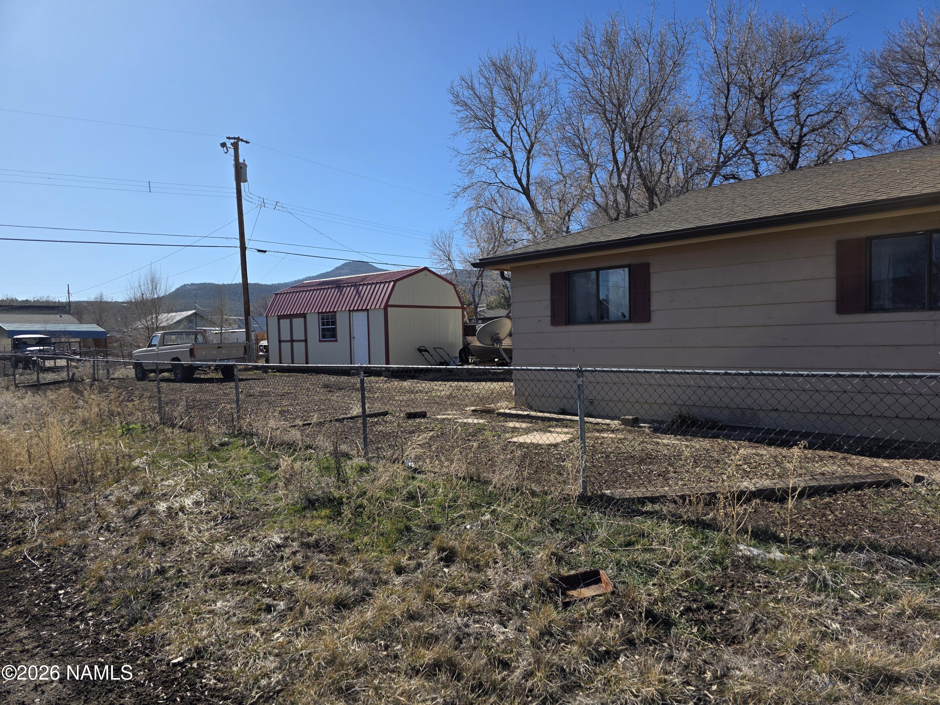 218 East Edison Avenue Williams, AZ 86046 - Photo 6 of 29 a backyard of a house with a yard and garage