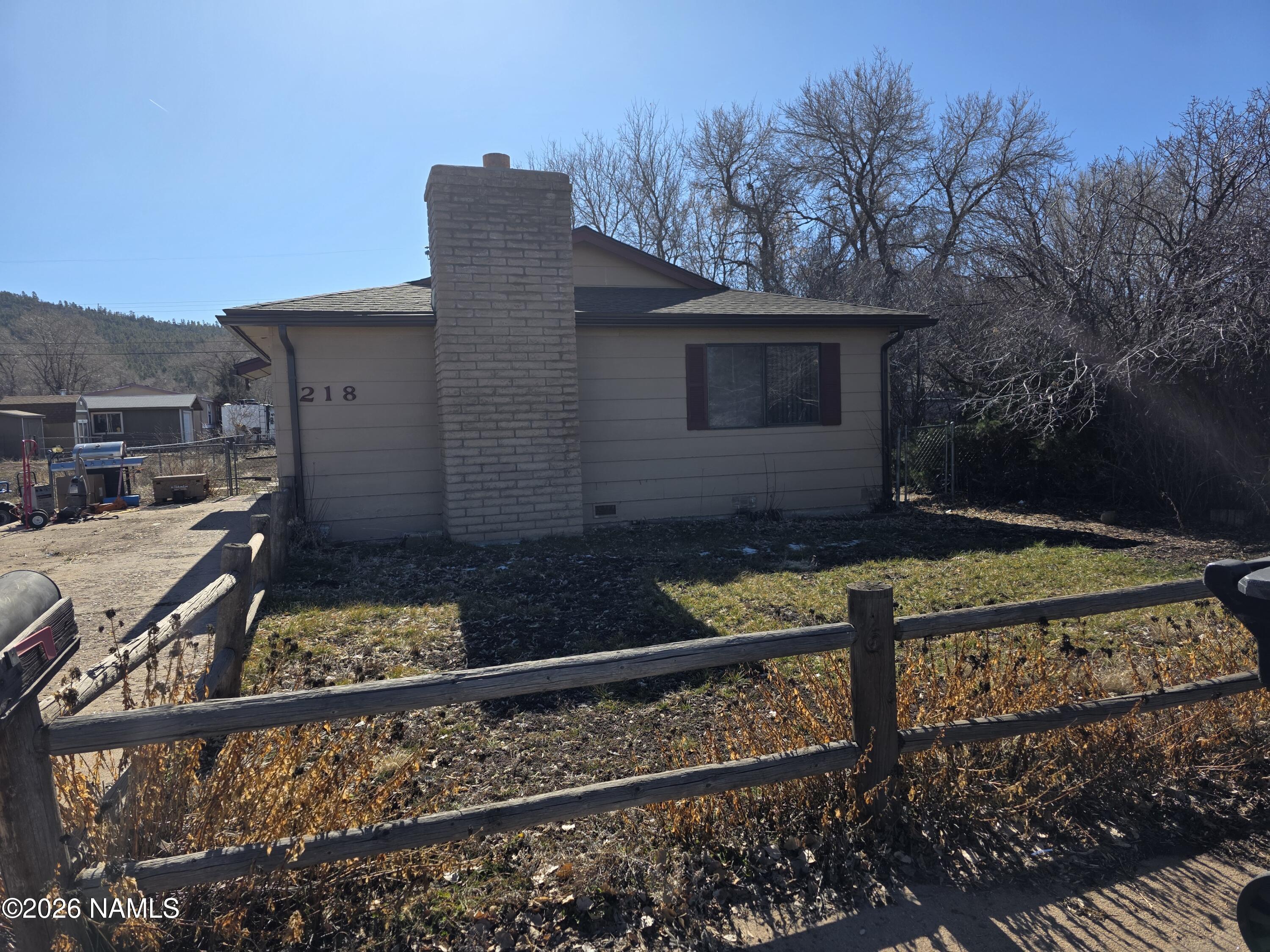 218 East Edison Avenue Williams, AZ 86046 - Photo 8 of 29 a view of a house with backyard and trees
