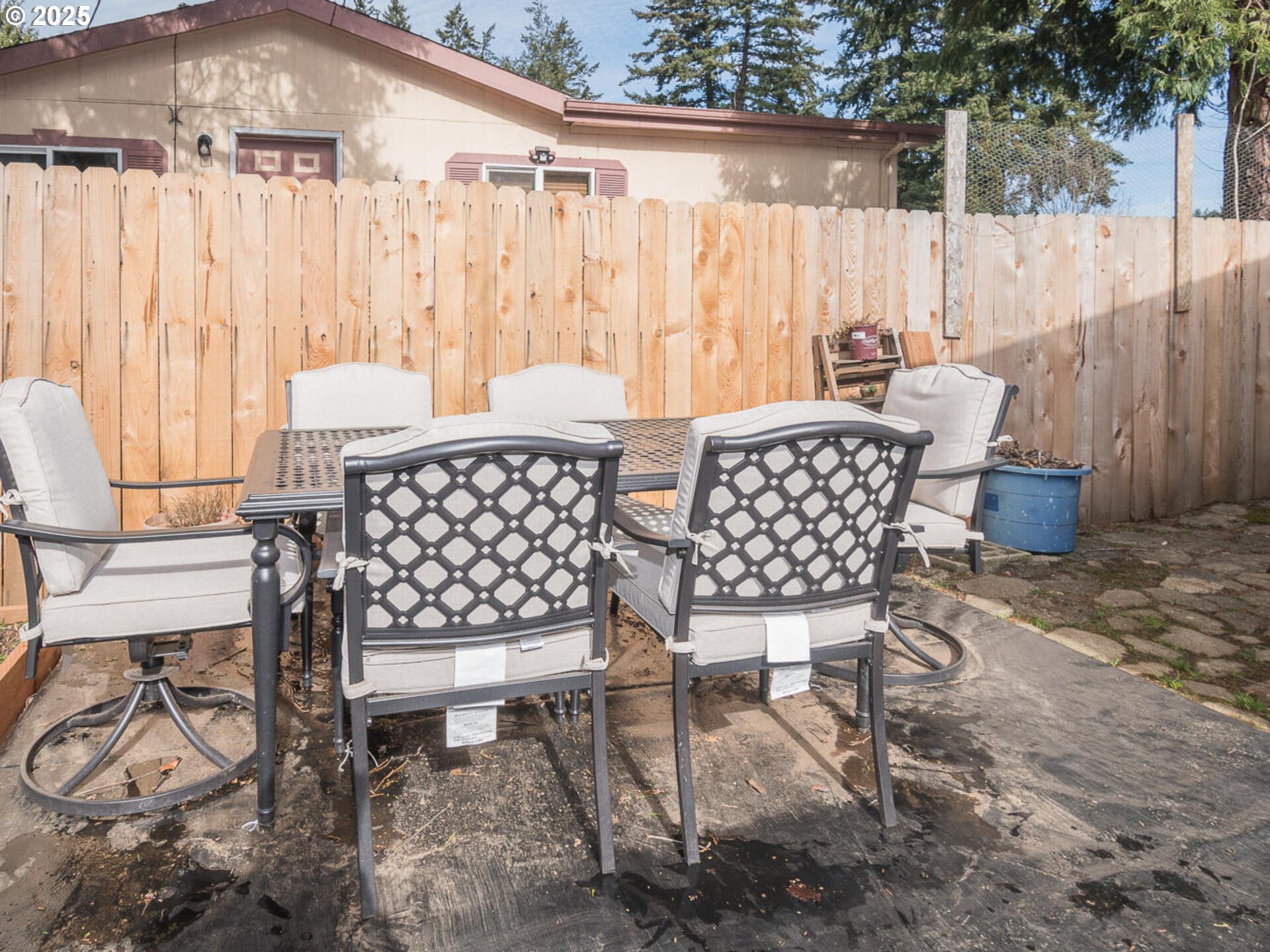 5200 Southeast 132nd Avenue, Unit 12 Portland, OR 97236 - Photo 11 of 17 a view of a patio with table and chairs with wooden fence
