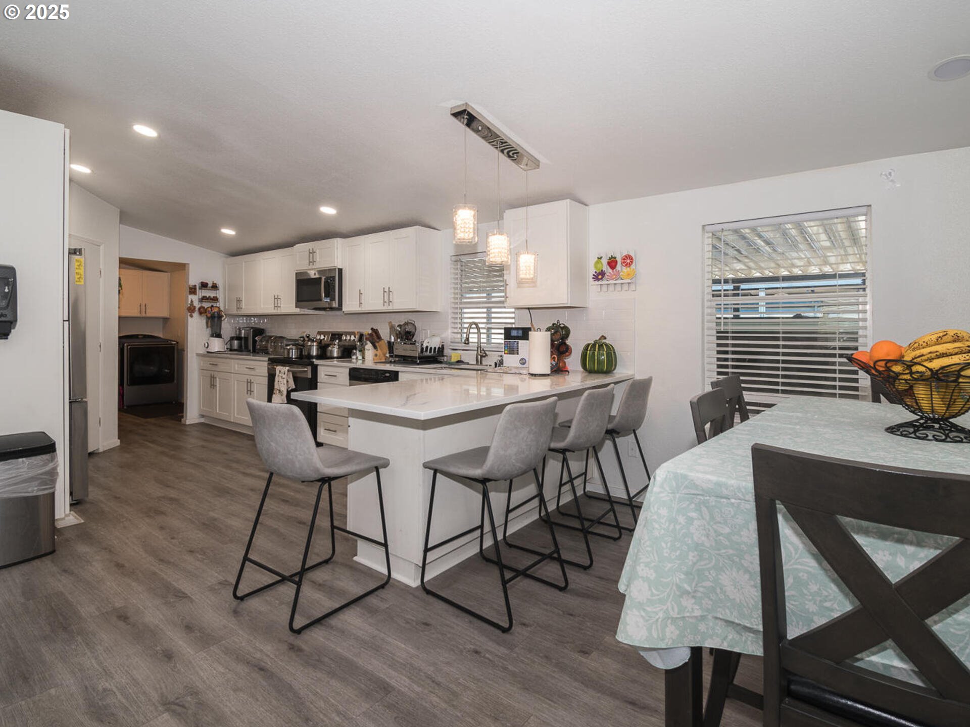 5200 Southeast 132nd Avenue, Unit 12 Portland, OR 97236 - Photo 12 of 17 a kitchen with stainless steel appliances a table and chairs in it