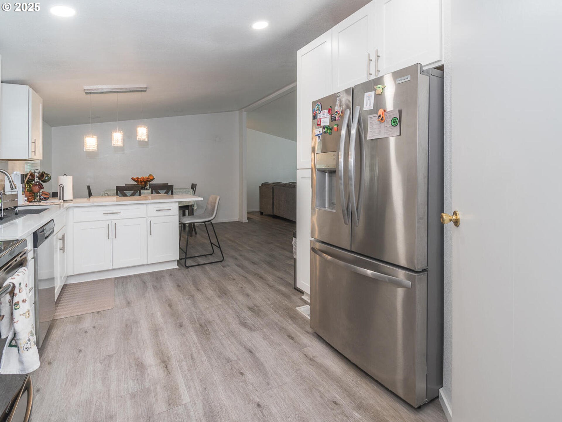 5200 Southeast 132nd Avenue, Unit 12 Portland, OR 97236 - Photo 14 of 17 a kitchen with stainless steel appliances granite countertop a refrigerator sink and white cabinets