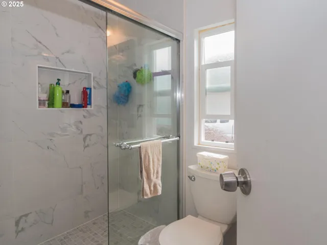 a white toilet sitting next to a bathroom sink