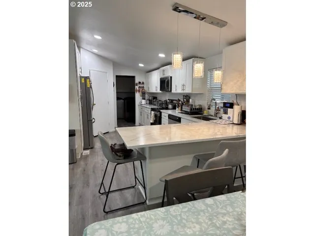 a kitchen with a sink appliances and cabinets