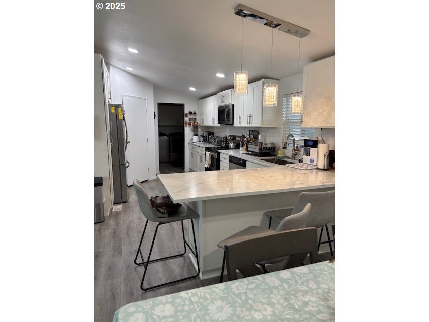 5200 Southeast 132nd Avenue, Unit 12 Portland, OR 97236 - Photo 4 of 17 a kitchen with a sink appliances and cabinets