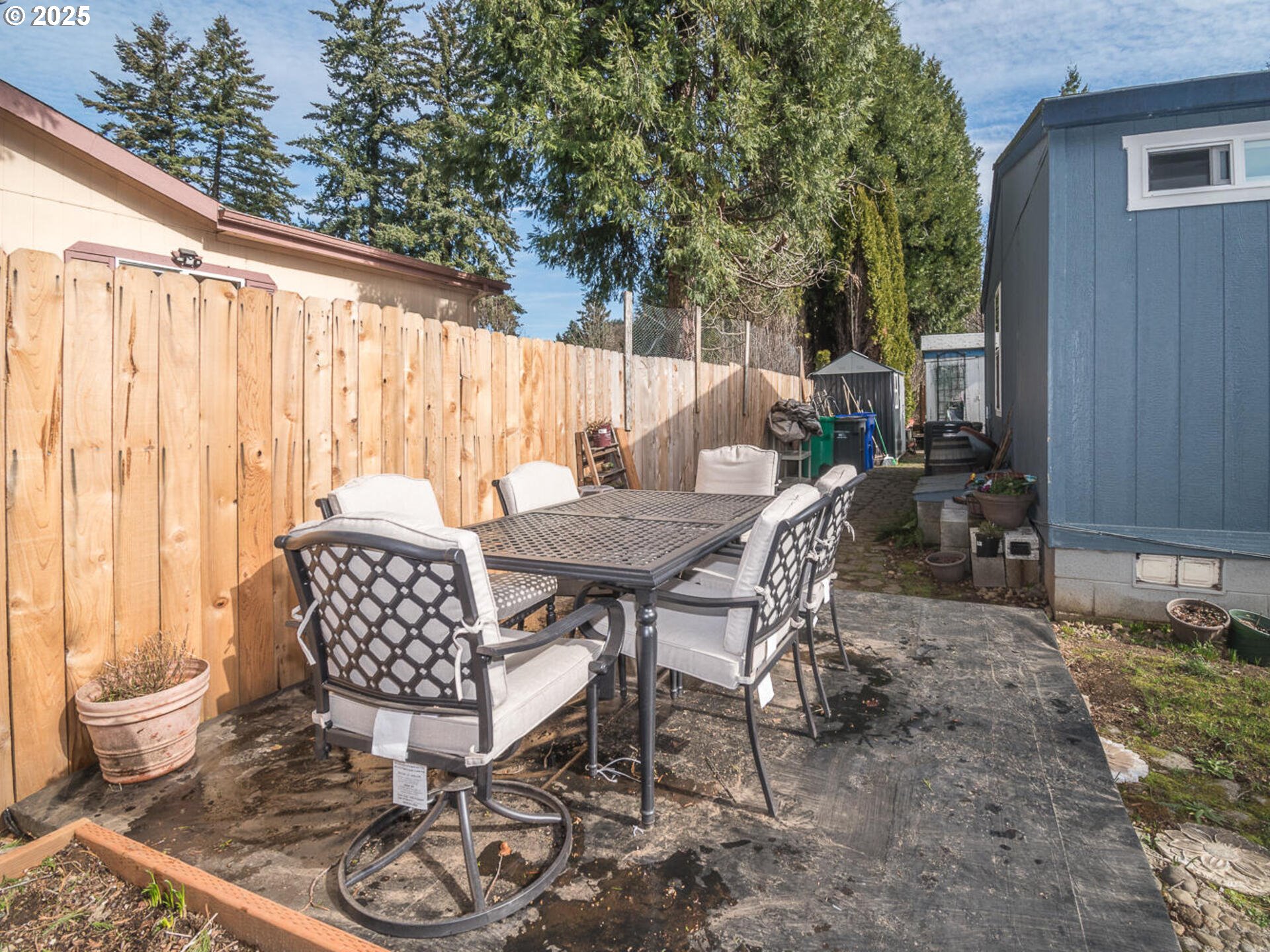 5200 Southeast 132nd Avenue, Unit 12 Portland, OR 97236 - Photo 10 of 17 a view of a patio with table and chairs and potted plants
