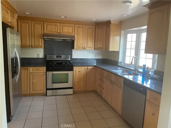 a kitchen with a stove sink and cabinets