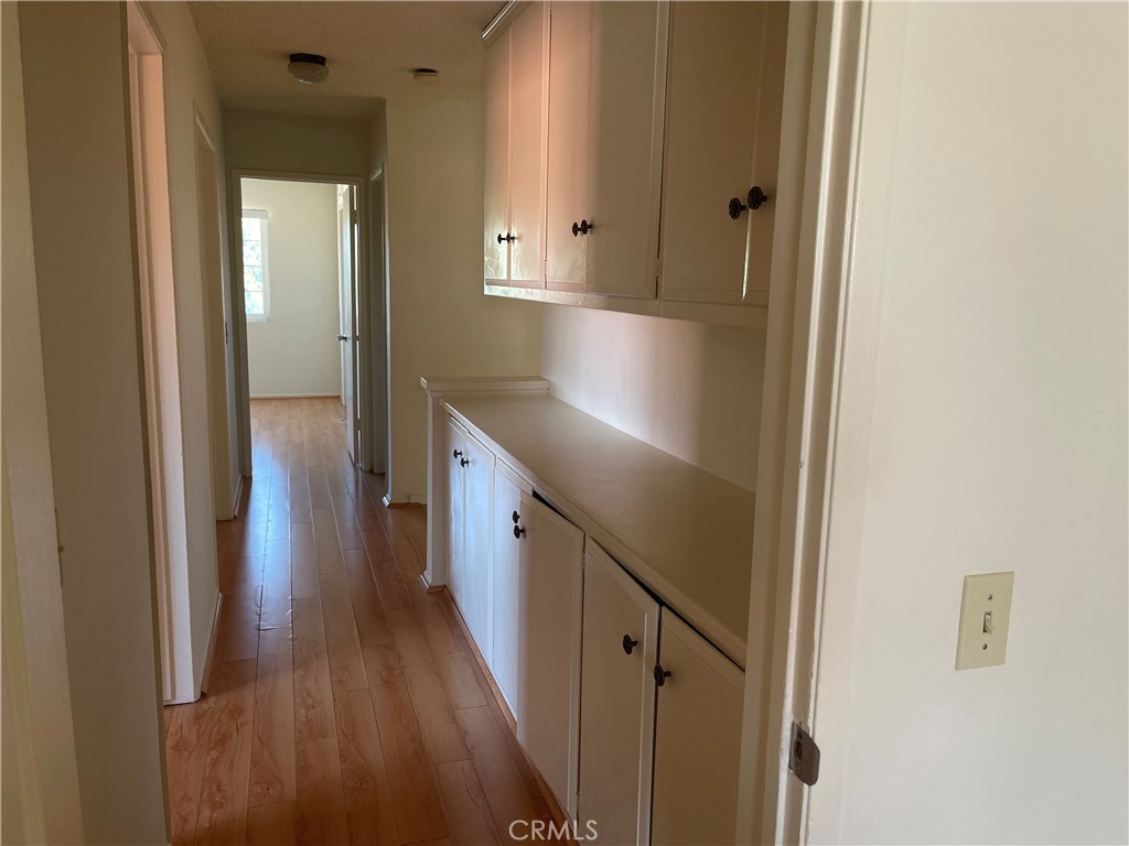 12418 Pine Creek Road Cerritos, CA 90703 - Photo 6 of 7 a view of a hallway with wooden floor