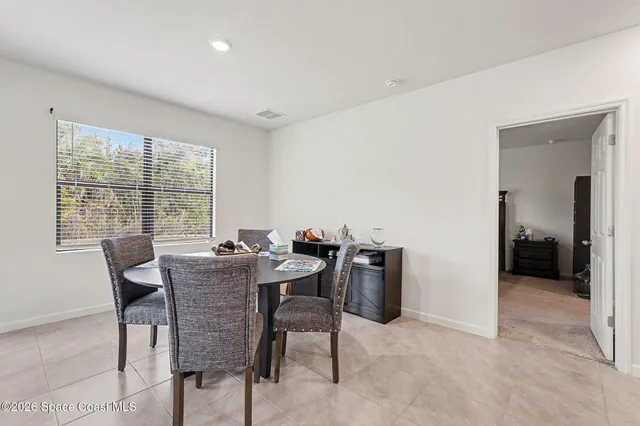 a view of a dining room with furniture and a window
