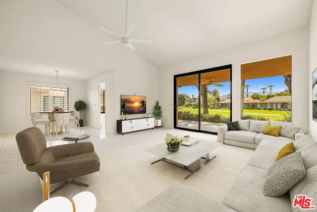 a bedroom with furniture and a large window