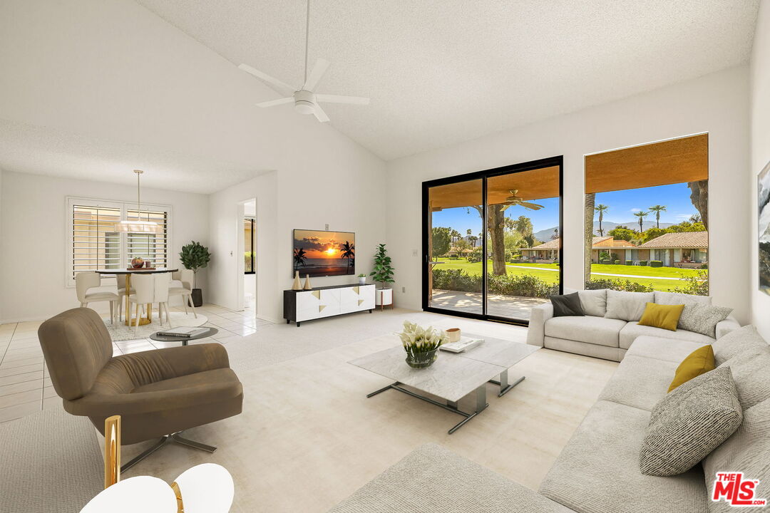 a bedroom with furniture and a large window