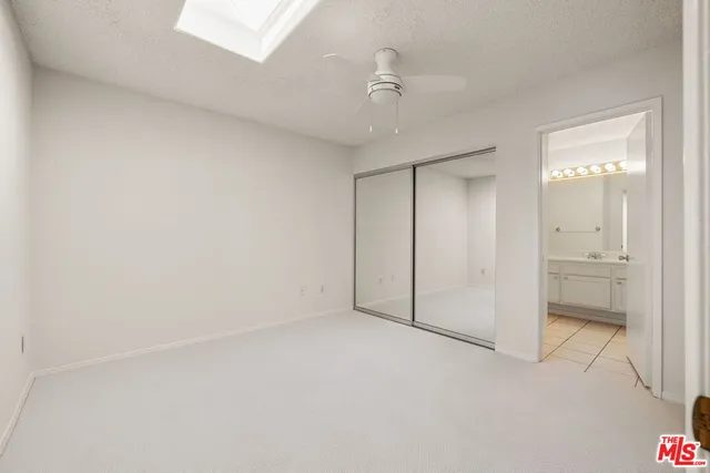 a view of an empty room and a bathroom