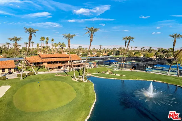 a view of a swimming pool with outdoor seating