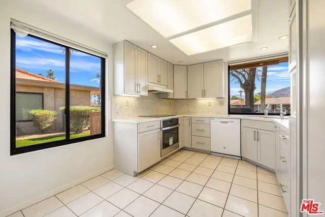 a kitchen with a stove a sink and a refrigerator