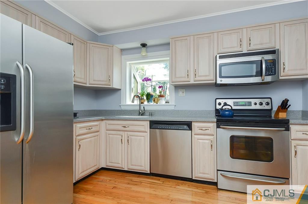 36 Harmony Road Randolph, NJ 07869 - Photo 7 of 22 a kitchen with stainless steel appliances granite countertop a stove a microwave and a refrigerator