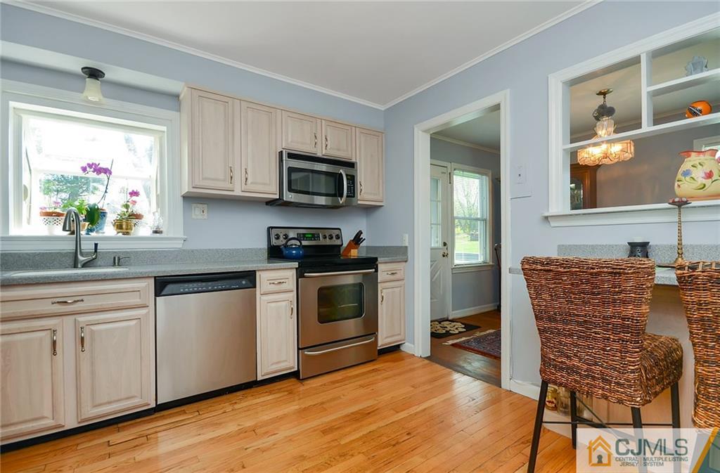 36 Harmony Road Randolph, NJ 07869 - Photo 9 of 22 a kitchen with stainless steel appliances a stove a sink and white cabinets