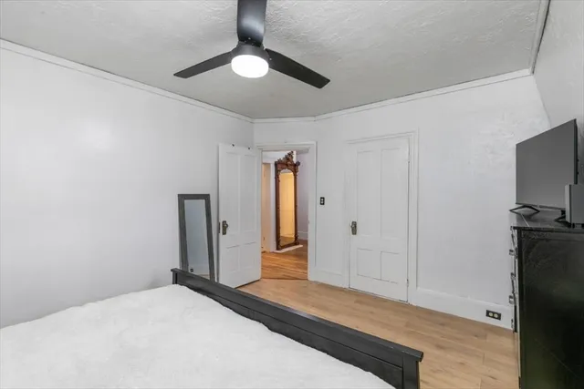 a bedroom with a bed and a flat screen tv