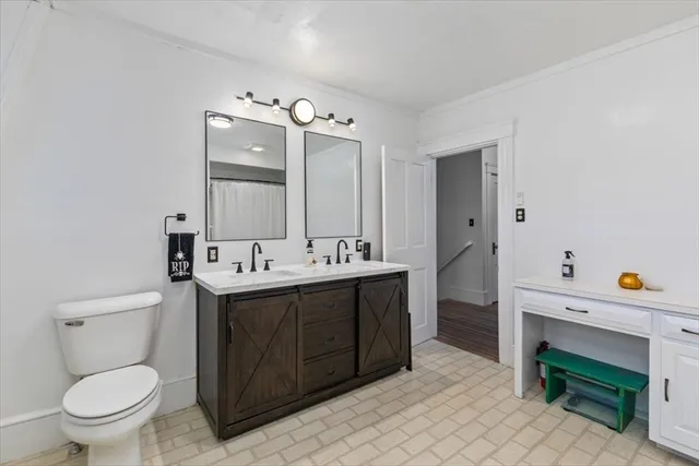 a spacious bathroom with a double vanity sink mirror and toilet