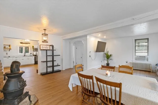 a dining room with furniture and wooden floor