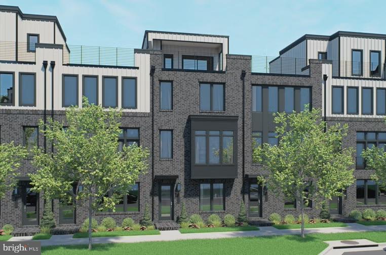 a front view of residential houses with yard and trees