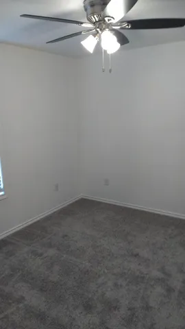 a view of an empty room with a fan