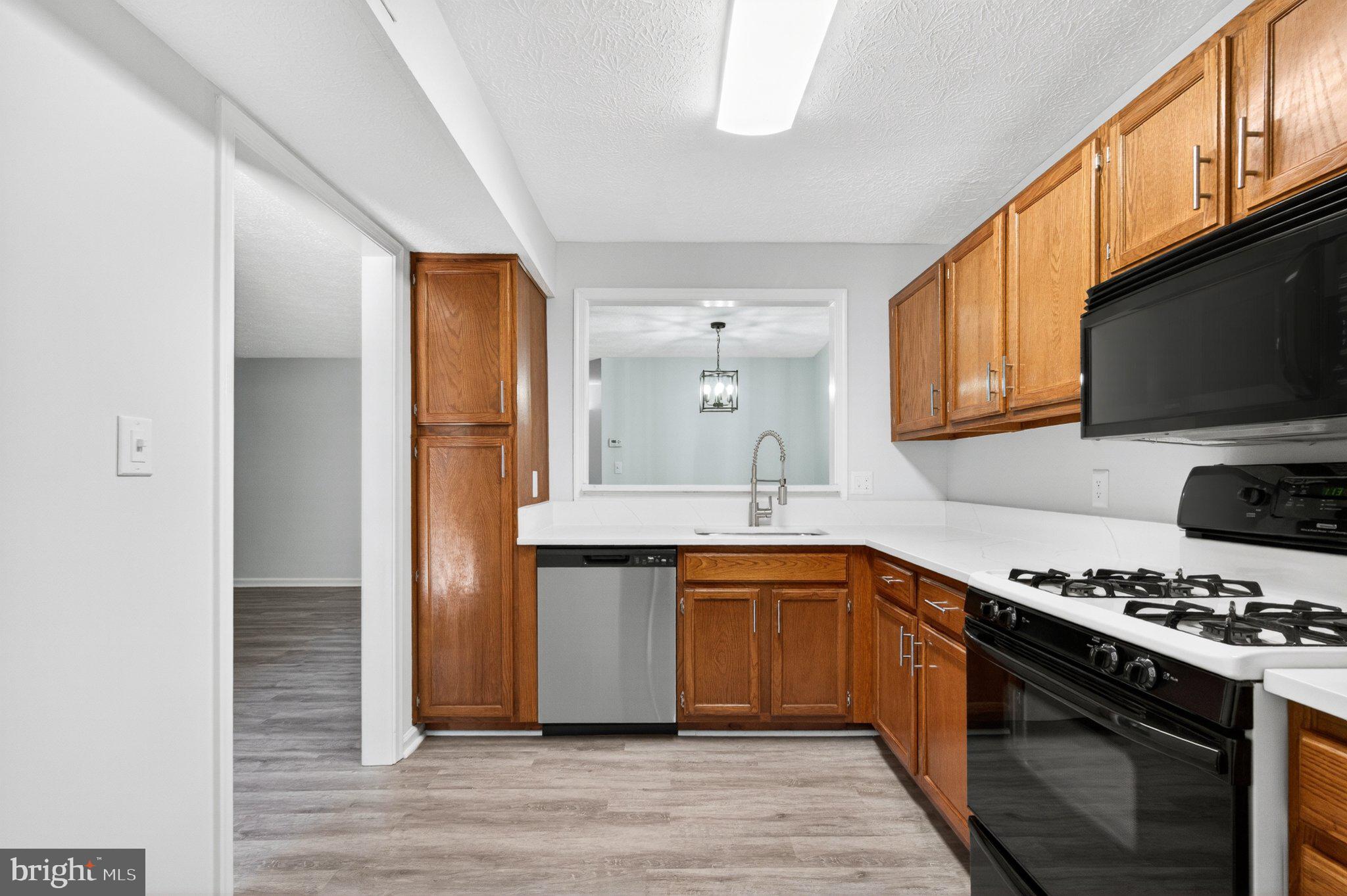 2281 Hunter's Run Drive, Unit 2281 Reston, VA 20191 - Photo 7 of 25 Modern kitchen with warm wood accents.