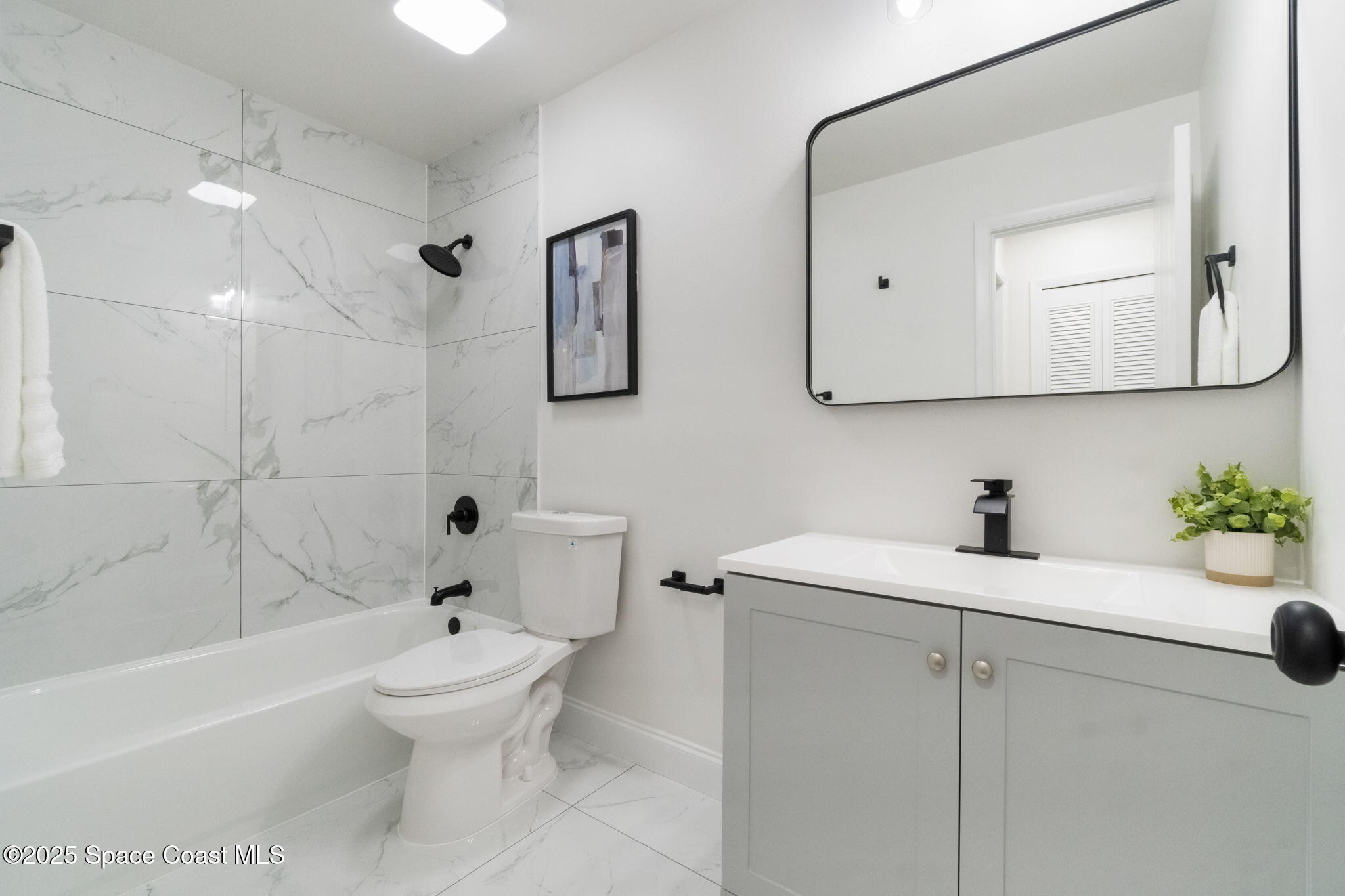 7115 Camilo Road Cocoa, FL 32927 - Photo 12 of 25 a bathroom with a sink a toilet and shower