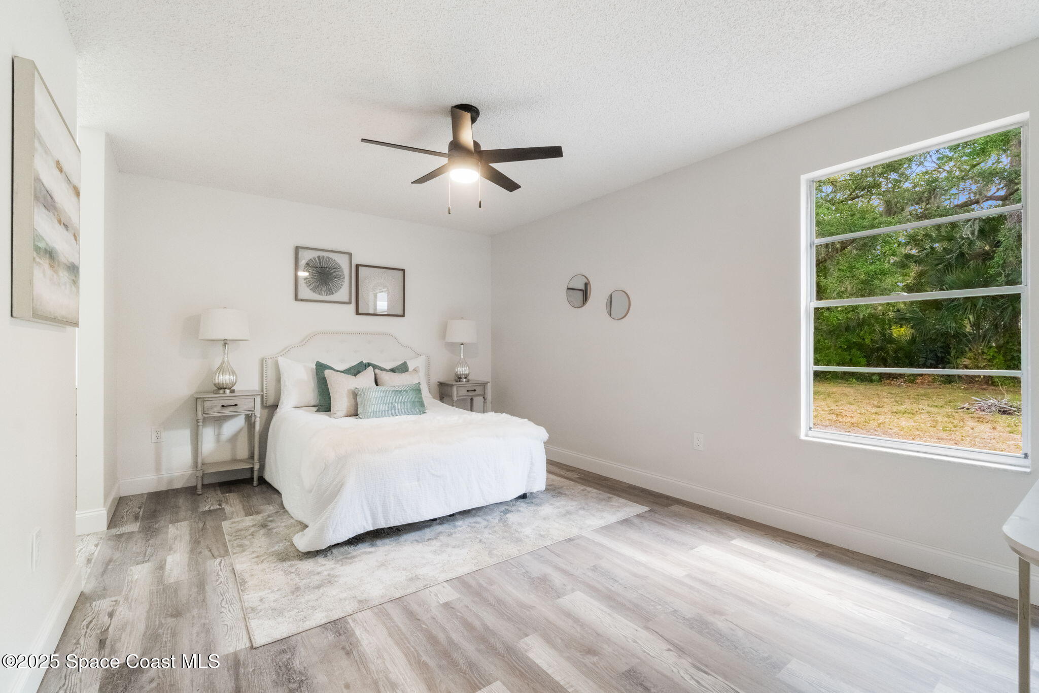 7115 Camilo Road Cocoa, FL 32927 - Photo 17 of 25 a bed room with a bed and a window