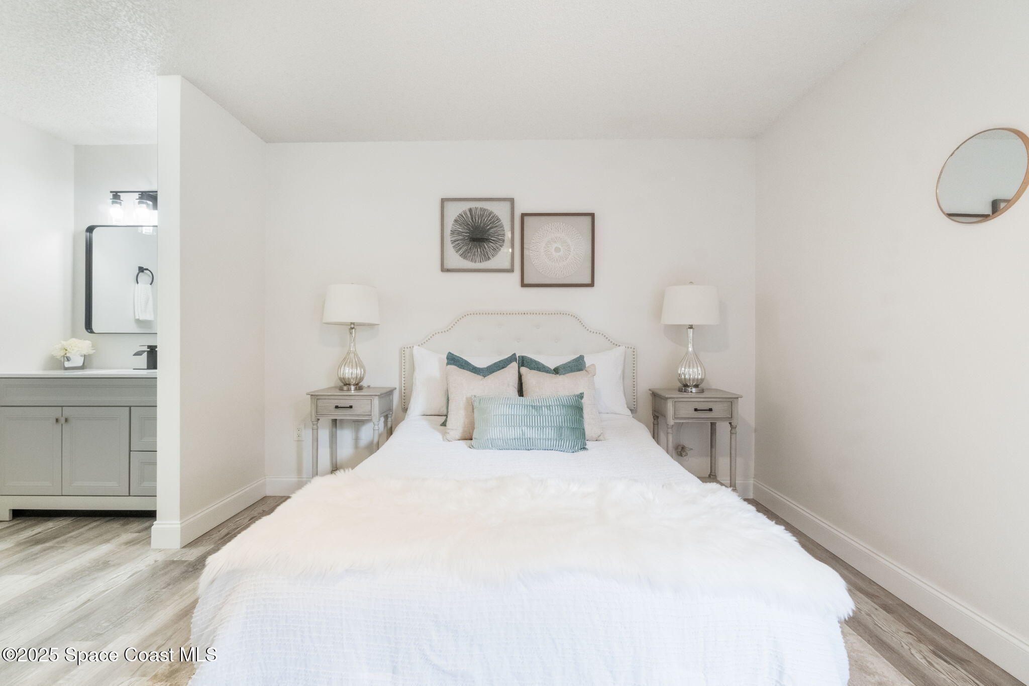 7115 Camilo Road Cocoa, FL 32927 - Photo 18 of 25 a bedroom with a bed and a chandelier