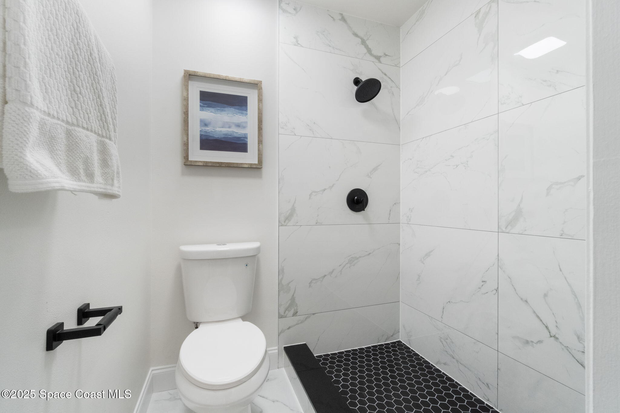 7115 Camilo Road Cocoa, FL 32927 - Photo 20 of 25 a bathroom with a toilet and a shower