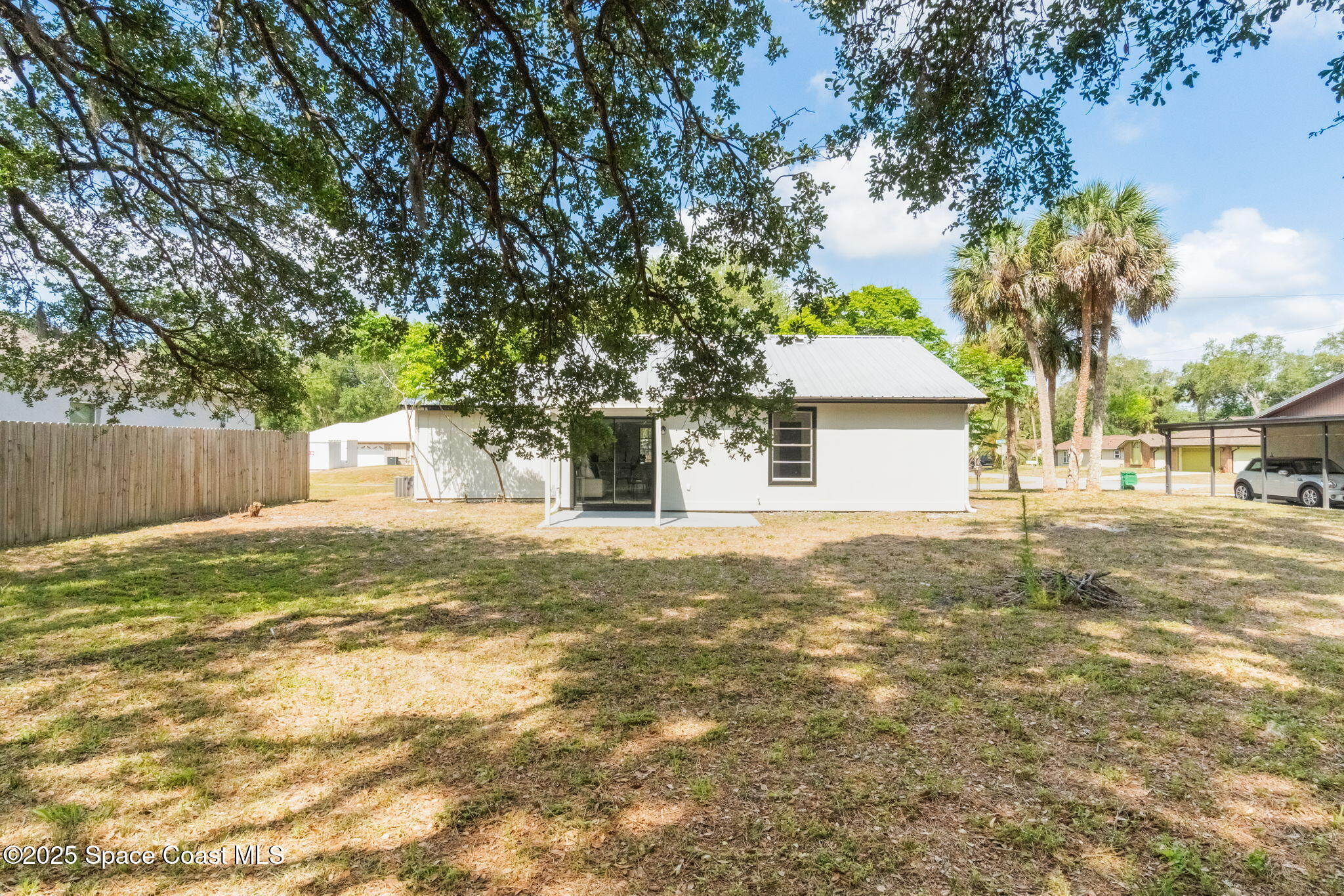 7115 Camilo Road Cocoa, FL 32927 - Photo 23 of 25 a front view of a house with a yard and garage